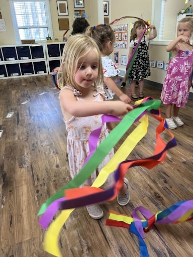 Girls Dancing with ribbon wands during the music and dance class