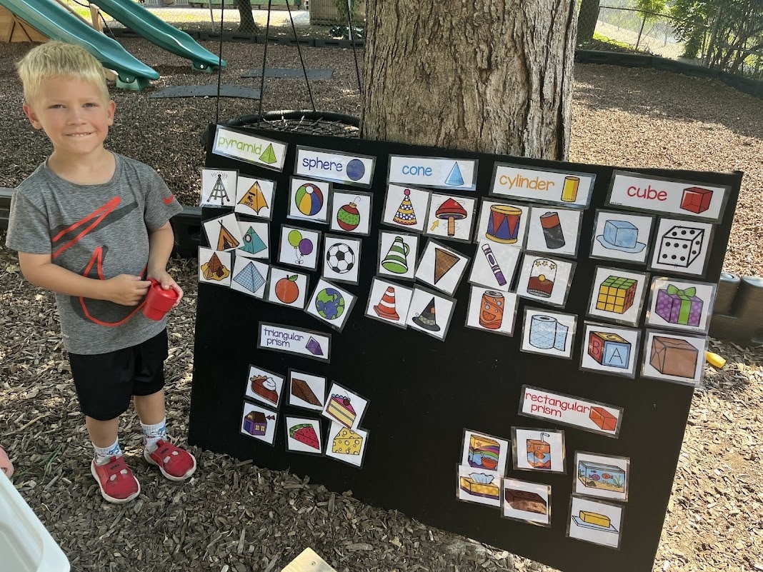 preschool student presenting shapes information to class in outdoor space