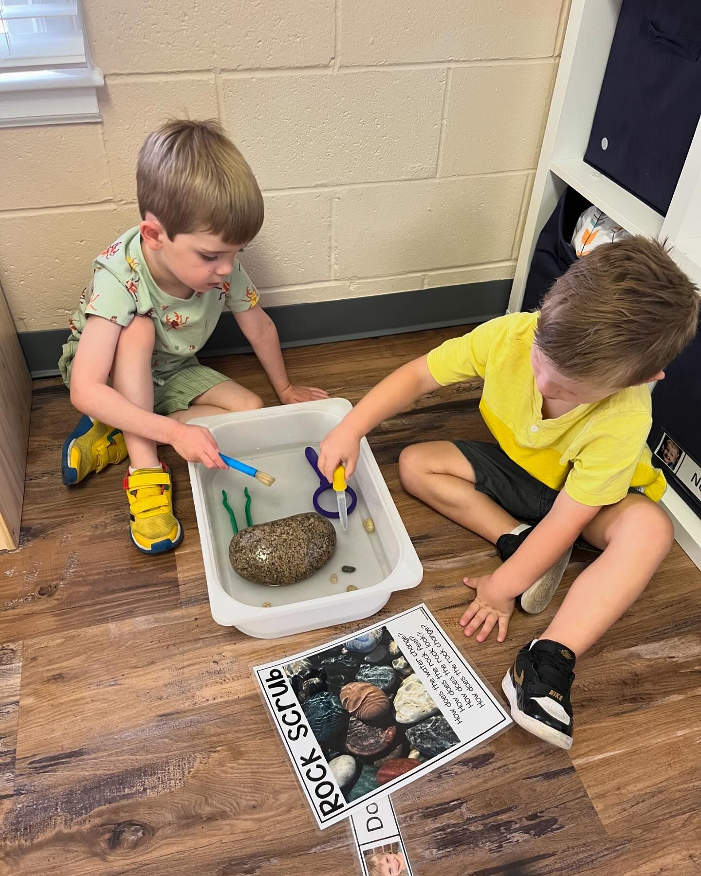 Montessori STEAM students examining and experimenting with rocks and tools as scientists