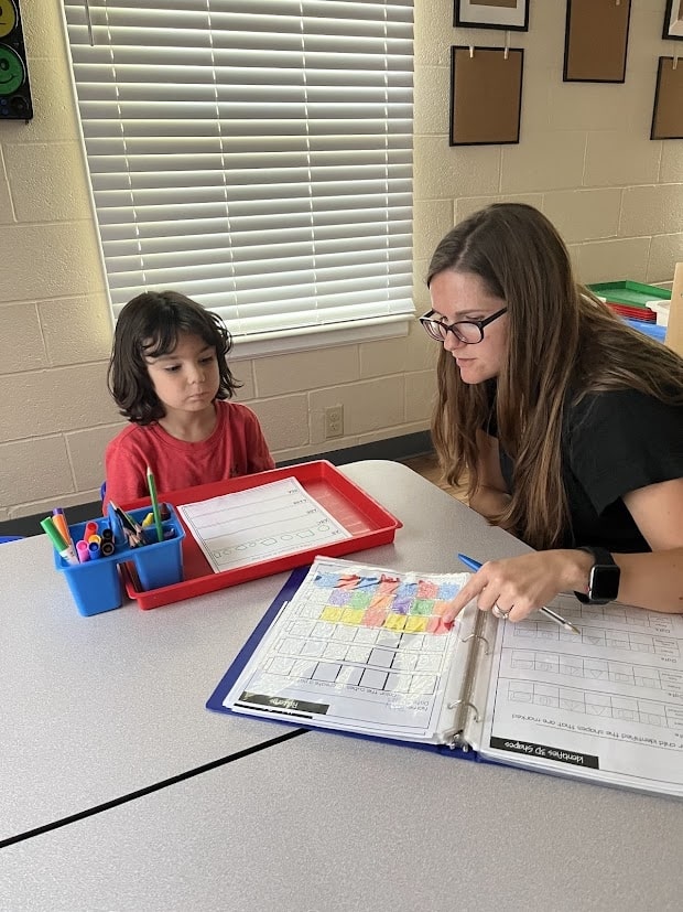 Teacher working one on one with student learning a new concepts