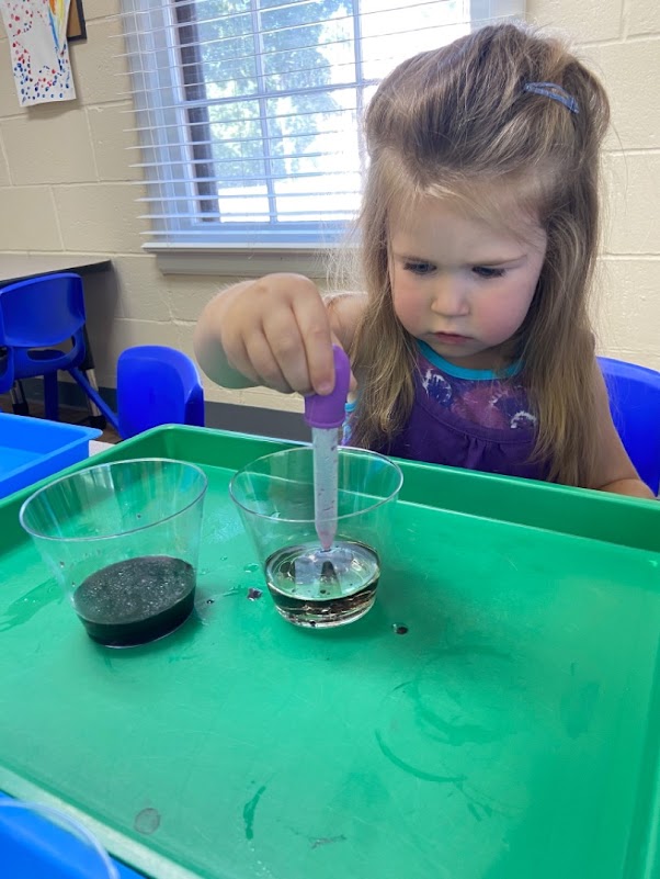 Preschool girl doing science experiment